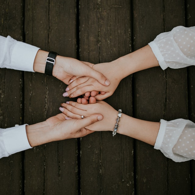 Man and woman holding hands together